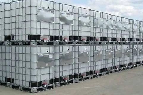 Rows of caged IBC totes in the yard